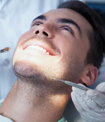 man smiling during his visit to Broadwing Dental Studio