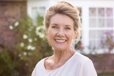 woman smiling with all-on-x dental implants from Broadwing Dental Studio