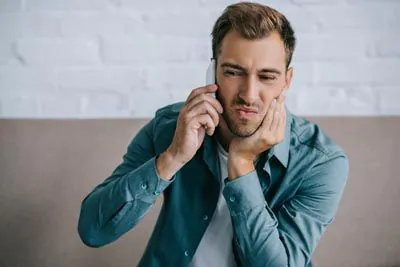 man calling Broadwing Dental Studio for emergency dental care
