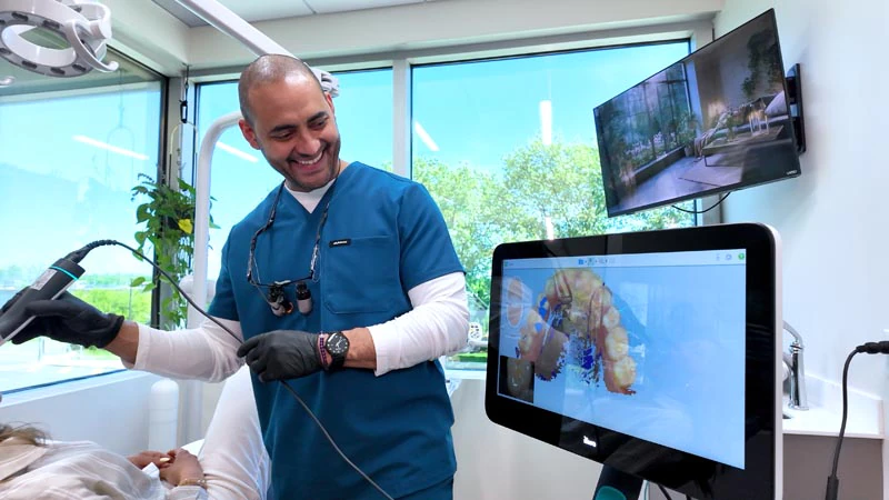 Dr. Soto taking x-rays of a patient's smile at Broadwing Dental Studio