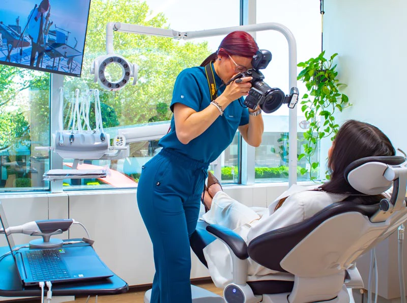Dr. Eduardo working with a patient to get them dental veneers