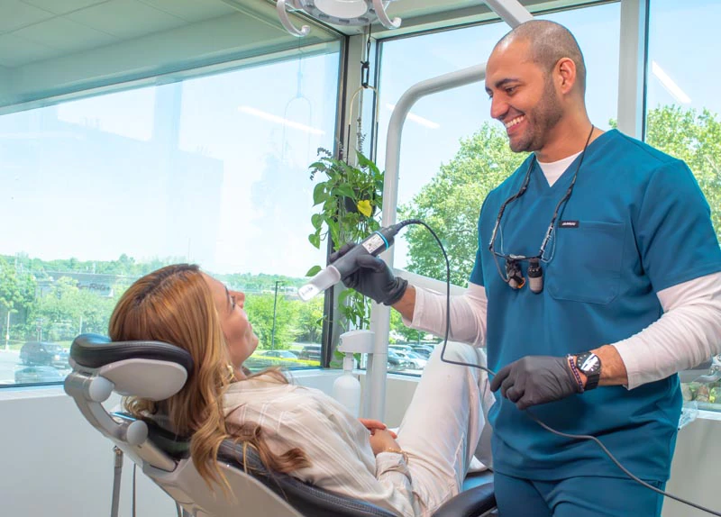 Dr. Soto cleaning a patient's teeth at Broadwing Dental Studio